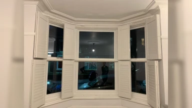 Tier on tier window shutters fully open at night in Sheffield