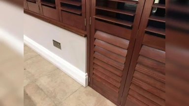 Dark red wood window and door shutters