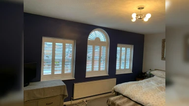 Arch shaped window shutter with fan detail
