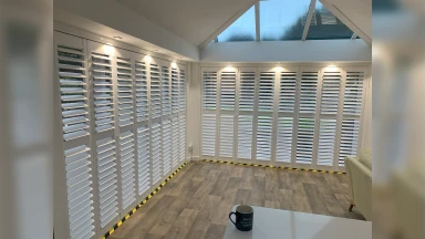 Corner shot of white tracked shutters