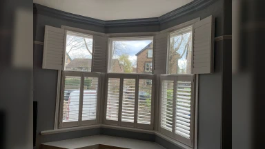 Half open tier on tier window shutters in bay window in Rotherham
