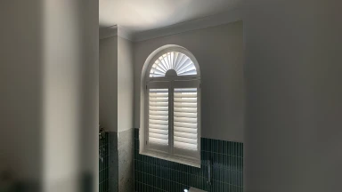 Arch shaped bathroom window shutters