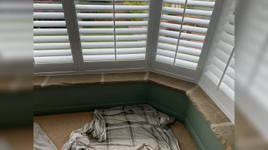 Bay window shutters fitted into an even stone window sill