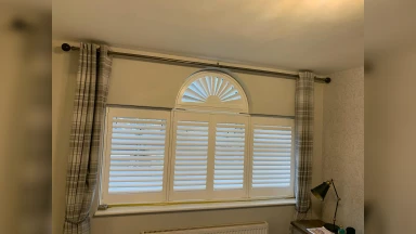 Sunrise shaped bedroom window shutter