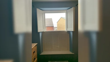 Small tier on tier window shutters with light blue walls