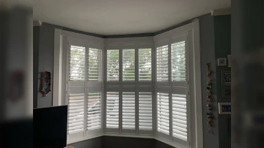 Tier on tier window shutters in a bay window