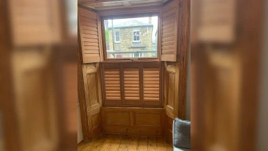 All wooden tier on tier window shutters with top doors open